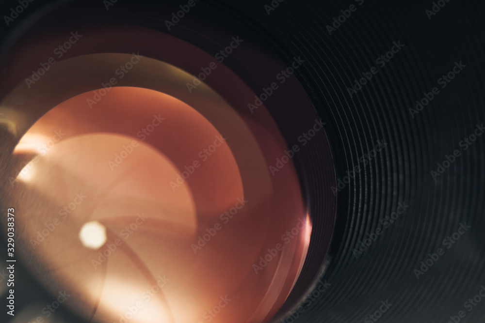 Poster Beautiful camera lens with orange  light of glass. Background pattern for design..