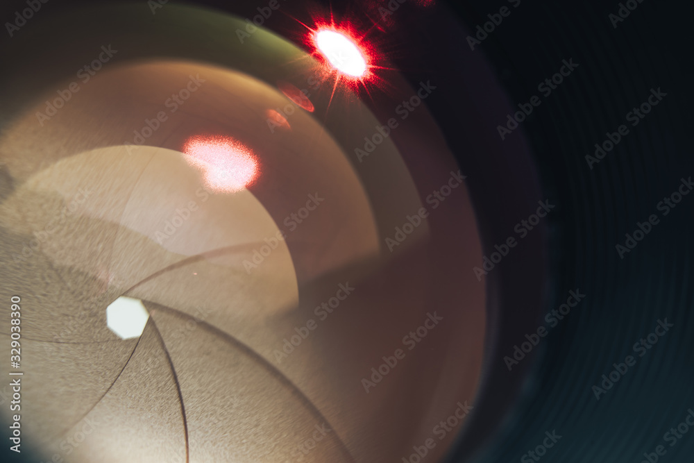 Poster beautiful camera lens with yellow and red light of glass. background pattern for design..