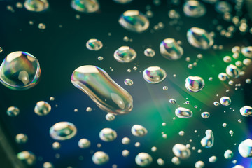 Close up beautiful abstract multi colored water drop of holographic effect. Background pattern for...