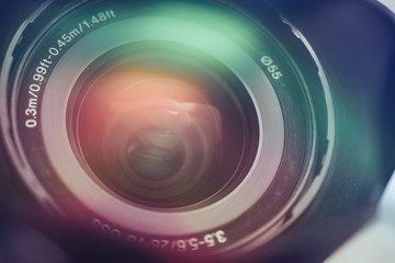Fototapeta na wymiar Beautiful camera lens with multi colored light of glass. Background pattern for design..