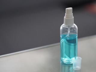 Alcohol 75% in a spray bottle placed on the table, prevent germs protect virus covid 19