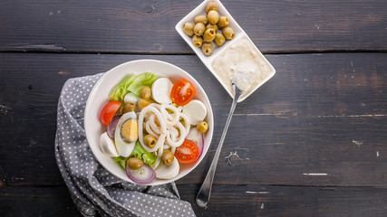 Seafood banner. Salad with squid rings. Restaurant dishes. Top view. Copy space