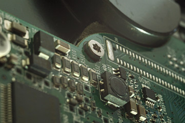 Fototapeta premium Micro circuit board bolt retainer close-up repair computer background engineering.