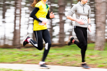Fototapeta premium Runners in a marathon race in blurred motion