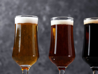 Choose from three different types of craft beer in glasses on a dark background