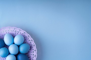 Fototapeta na wymiar Easter eggs are blue and light blue in a beautiful purple. basket. spring composition, flatlay