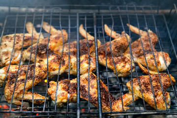 Delicious Grilled  Chicken  wings  over the Coals on a Barbecue. Picnic food. Roasting chicken wings.