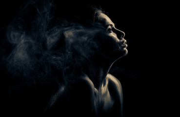 Emotion black and white woman's portrait. Soul pain on face. Smoke around her head