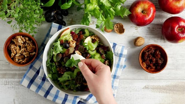 Waldorf Salad. Decorating the dish. Lay the basil leaf on the sauce.