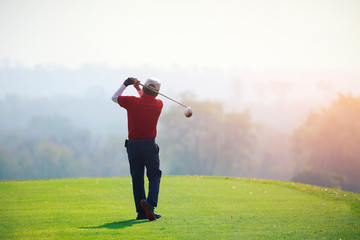 mature man playing golf on a golf course in the summer morning - Powered by Adobe