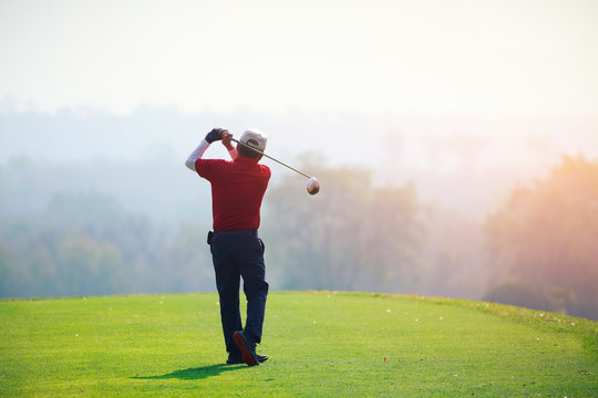 Mature Man Playing Golf On A Golf Course In The Summer Morning