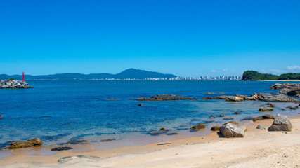  no horizonte a cidade de Itapema com o mar  em diversos tons 