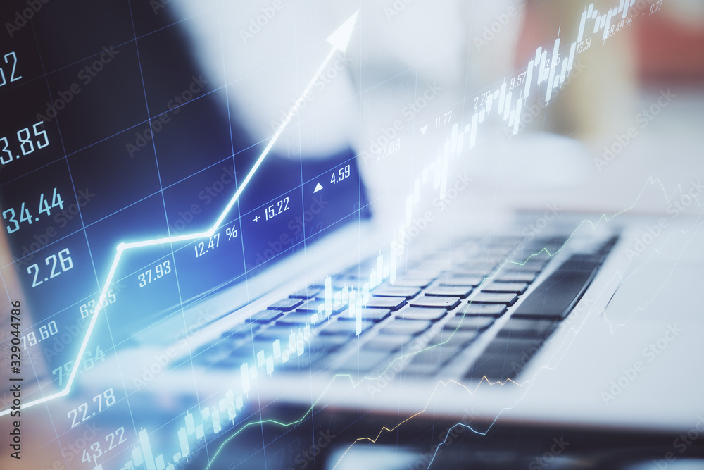 Aufkleber laptop on table with stock chart