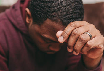 black african american man depicting a sad depressive state, depression concept - Powered by Adobe
