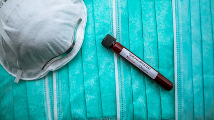 Protective mask and positive COVID-19 test. Laboratory sample of blood