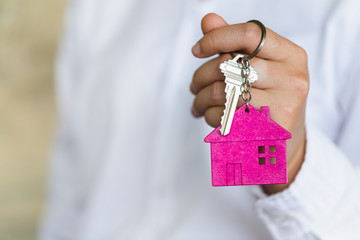 Real estate agents are delivering keys to clients. Concept Mortgage, lease, purchase and insurance for housing.