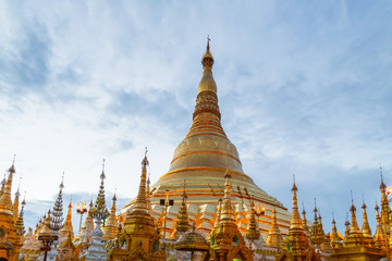 Fototapeta premium Domes of Shwedagon Pagoda against blue sky. Yangon, Myanmar (Burma). Travel Asia.