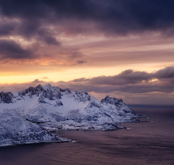 Mountains and sky during sunset. Senja island, Norway. Clouds on the sky during sundown. Nature background.
