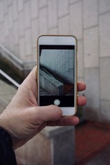hand man holding a smartphone, using the technology