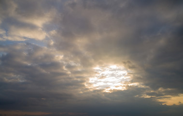 Dark cloudy sky with red reflections at sunset.