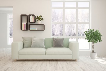 Modern living room in white color with sofa and winter landscape in window. Scandinavian interior design. 3D illustration