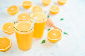 fresh orange Juice and oranges on the cutting board