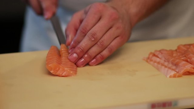 Cutting georgeous red fish fillet into neat slices