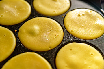 pancake frying pan with smile face pancake cooking on cooker in kitchen