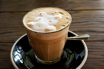 Hot latte coffee on a wooden table