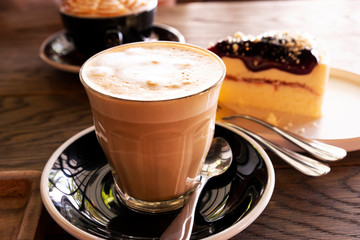 Hot latte coffee on a wooden table