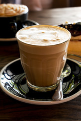 Hot latte coffee on a wooden table