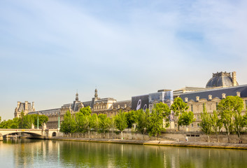 Fototapeta na wymiar Seine River Embankment and the Louvre Museum Façade