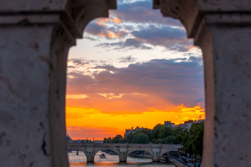 Sunset on the River Seine Through the Granite Fence of the Bridge