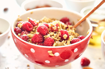 healthy breakfast, oatmeal with raspberries and honey, top view