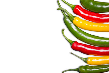 Color chili peppers. Hot spicy food ingredient. Red, yellow and green peppers isolated on white. Empty copy space vegetable background.