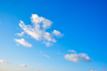 Clouds on a blue sky, background. Copy space for text, white clouds in the afternoon