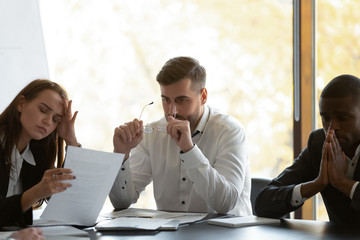 Mixed race frustrated group of employees feeling unmotivated fatigued. Young unhappy woman...