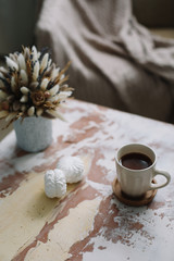 Coffee cup with flowers. Stylish flat lay. Home decoration. Cozy warm image, hygge style