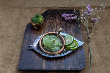 Traditional Thai dessert call candied kaffir lime on wooden background.
