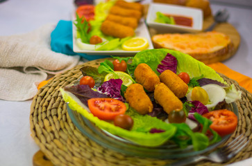homemade chicken croquettes with tomato and lettuce