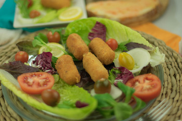 Chicken croquettes in transparent glass dish with garnish