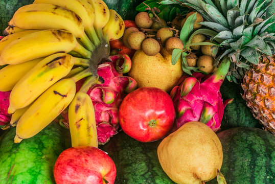 A picture of tropical fruits, banana, pineapple and others