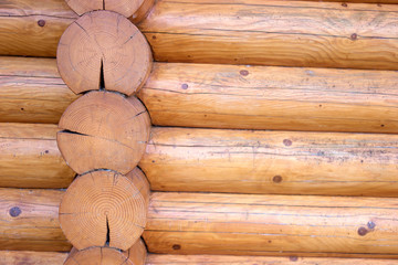 Round logs on wooden cabin house. Close up.