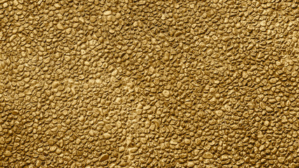 Golden pattern. Golden background and texture. Yellow gravel. Stone wall