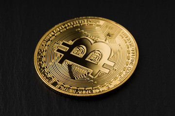Bitcoin coin on slate background. Close up .  Investment, gold.