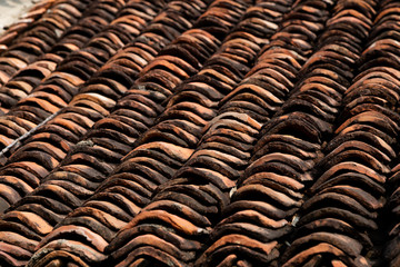 old clay roof tiles close up as background