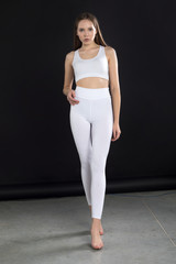 Girl in white blank leggings and a crop top. Mock-up.