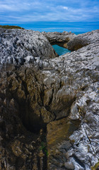Aerial landscape of Cobijero beach and the natural arch El Salto del Caballo, Buelna, Llanes council, Asturias, Cantabrian Sea, Spain, Europe