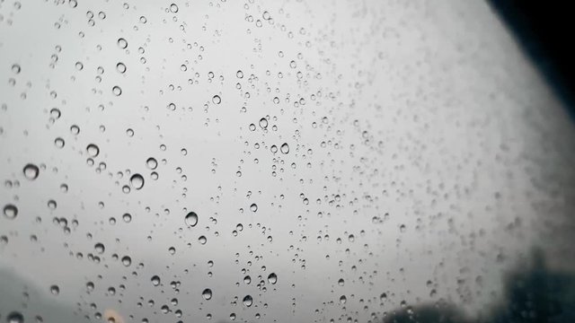 Rain drops on a window on an autumn day.