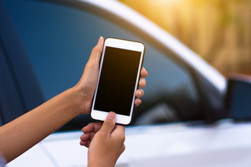 Hand holding mobile smart phone application to start car technology smart life 5G